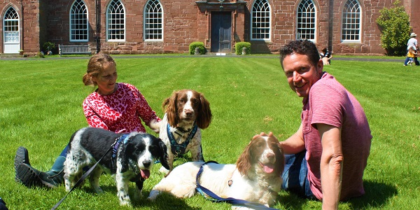 A man, a woman and two spaniels outside at Hartlebury Castle