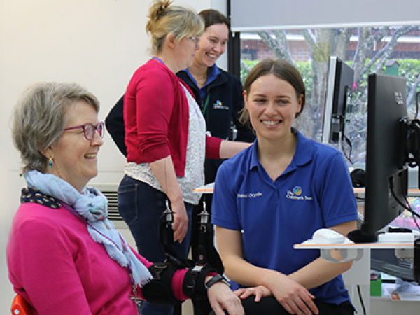 Image containing a picture of staff demonstrating neurotech to visitors at the 2024 Neurorehabilitation showcase