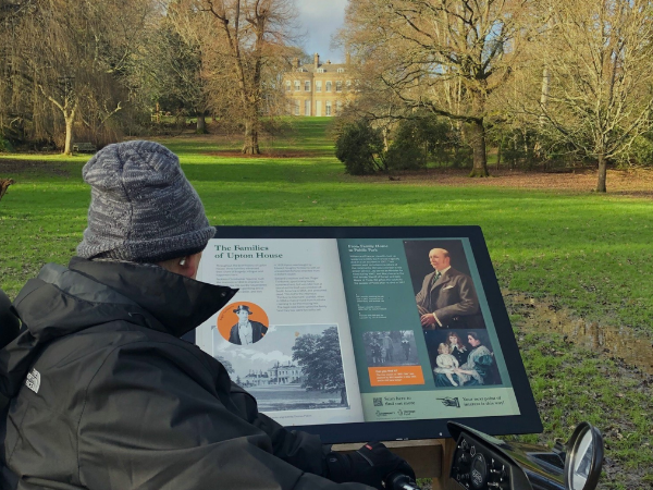Tramper user looking at one of our interpretation boards with information about the Country Park