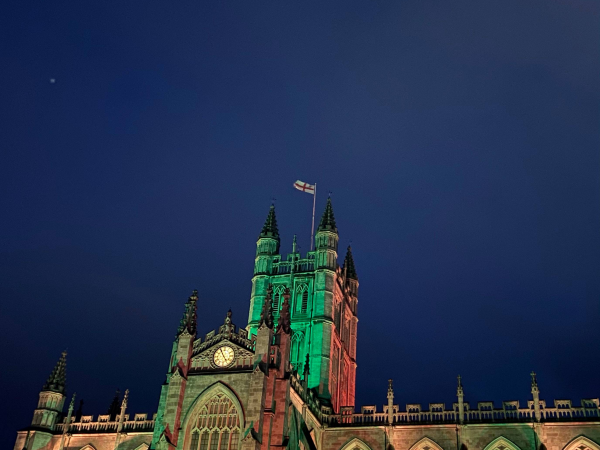 An image of Bath Abbey illuminated against a night sky