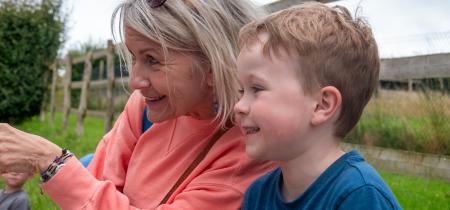 Grandmother and grandson sitting on a bench