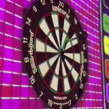 Dart board on a bright pink digital screen