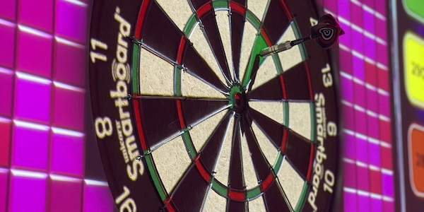 Dart board on a bright pink digital screen