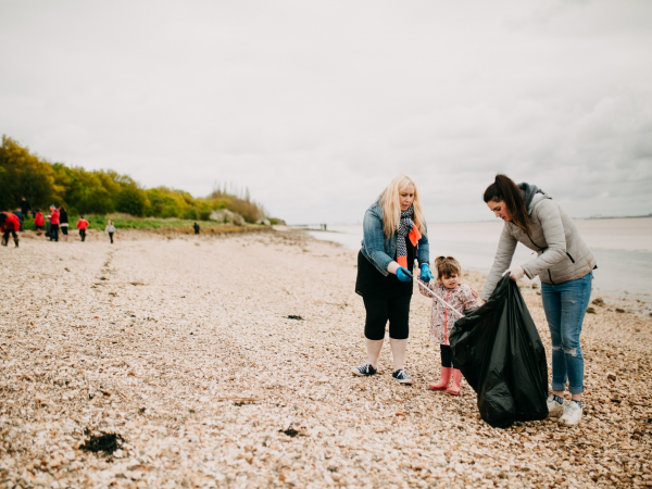 A family taking part in a beach clean