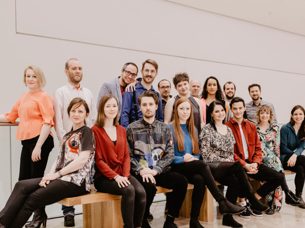 A large group of people smiling.