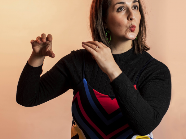 A woman pretending to play a flute.