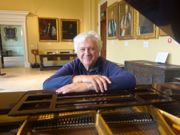 Older gentleman sitting at a piano