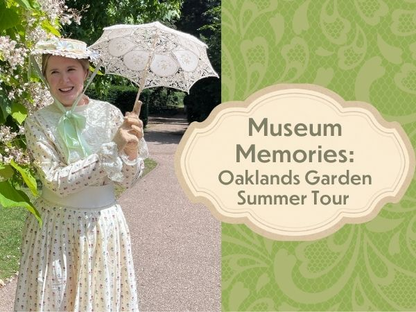 Rachel dressed as Mrs Wells in the walled garden with a white laced parasol
