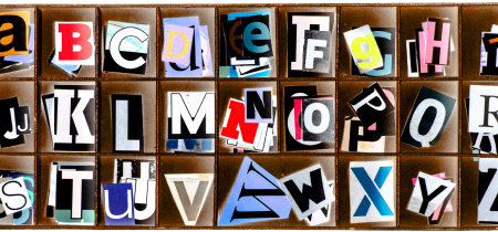 Cut out letters organised in a wooden box.