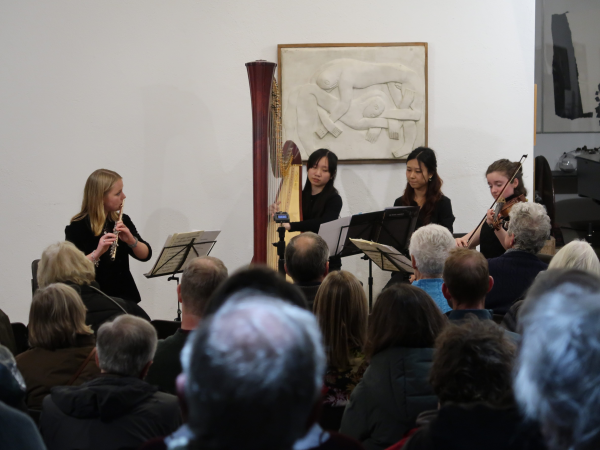 A group of student musicians performing in the Kettle's Yard house.