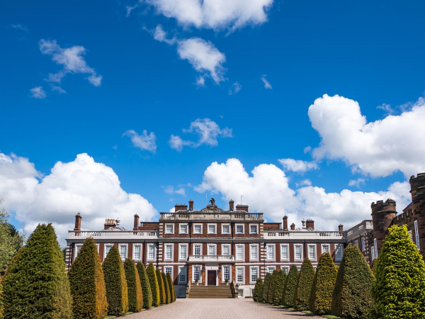 Front of Knowsley Hall stately home with blue sky