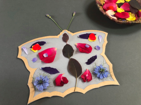 Butterfly shaped suncatcher with petal decorations
