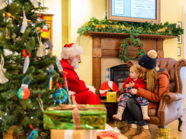Father Christmas greeting visitors