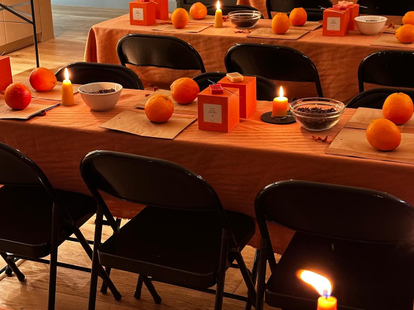 Tables with candlelight, oranges and various workshop items
