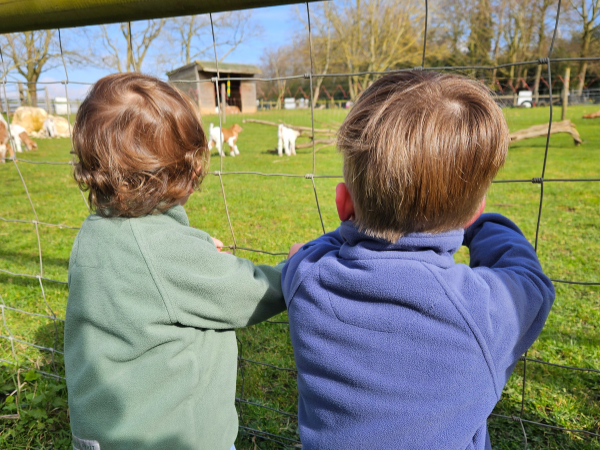 A child plays with a toy car in a mud