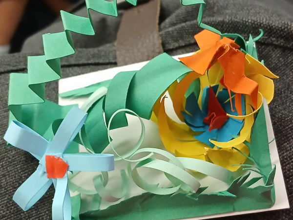 An example of cut and folded coloured paper made into a paper garden