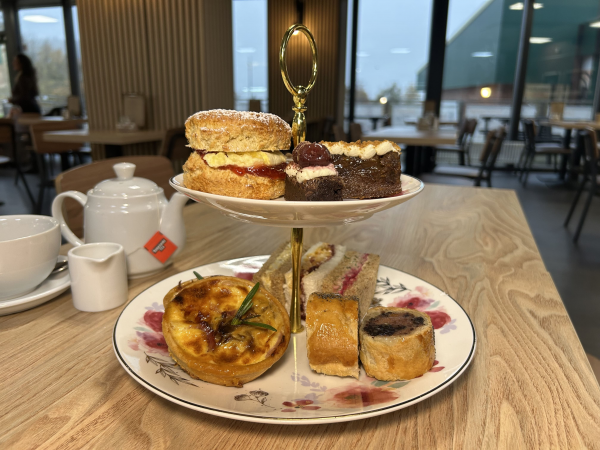 afternoon tea with sandwiches, a bottle of fizz, mini trifles, cakes