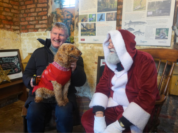 Dog and owner meeting Santa in the Castle's nature bothy