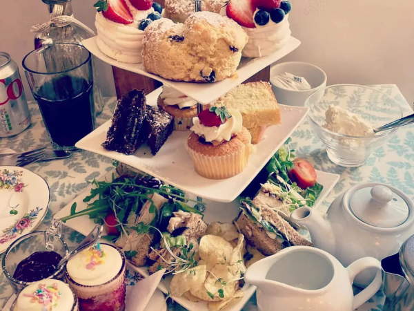 afternoon tea with sandwiches, a bottle of fizz, mini trifles, cakes