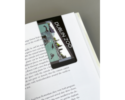 a rectangle magnetic bookmark displaying a art image of sealions and a child.