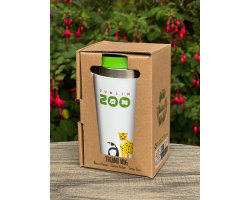 Thermal mug sitting on a table with a green lid displaying the zoo logo and an art image of a penguin, leopard, bongo and giraffe.