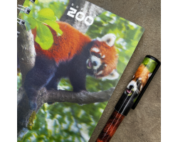 a spiral bound notebook with a cover displaying the dublin zoo name and a photo of a red panda on a tree branch.