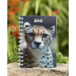 a spiral bound notebook with a cover displaying the dublin zoo name and a photo of a cheetah.
