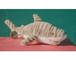 Grey fluffy shark toy with darker grey stripes and white underbelly