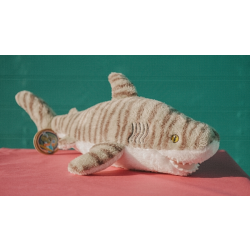 Grey fluffy shark toy with darker grey stripes and white underbelly