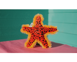 red, fluffy starfish soft toy with black spots