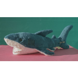 Dark blue fluffy shark toy with white underside.