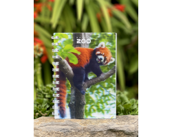 a spiral bound notebook with a cover displaying the dublin zoo name and a photo of a red panda on a tree branch.