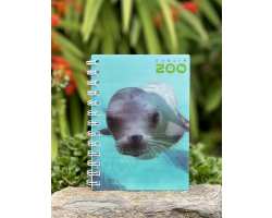 a spiral bound notebook with a cover displaying the dublin zoo name and a photo of a sealion under water.